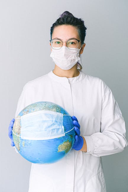 5 : img_3 - Professional in scrubs holding masked globe